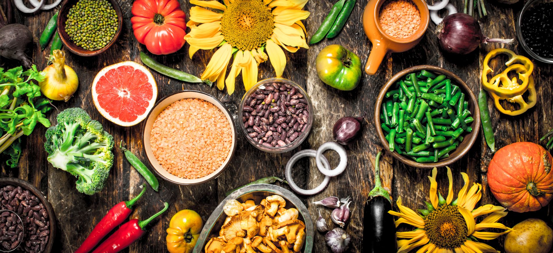 Eine Auswahl an Bio-Lebensmitteln auf einem hölzernen Hintergrund in der Ansicht von oben